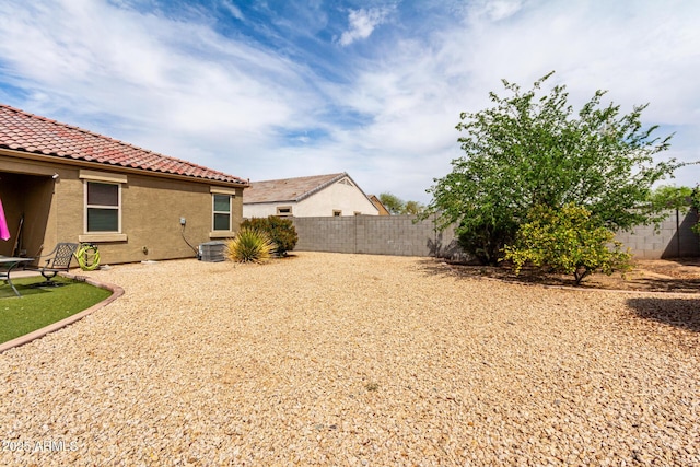 view of yard with a fenced backyard and central air condition unit