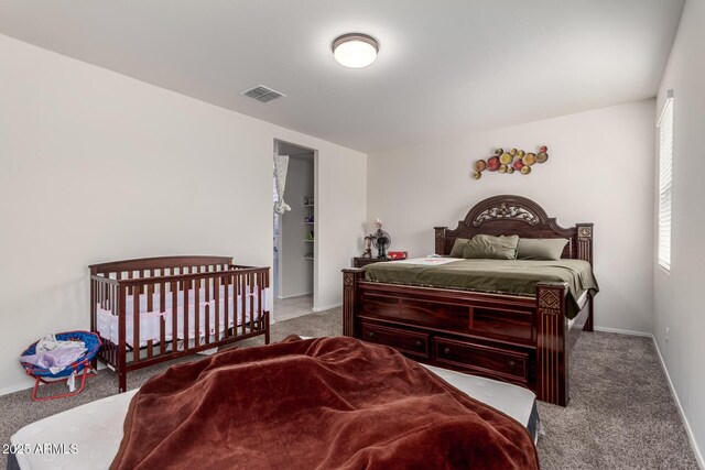 carpeted bedroom with baseboards and visible vents