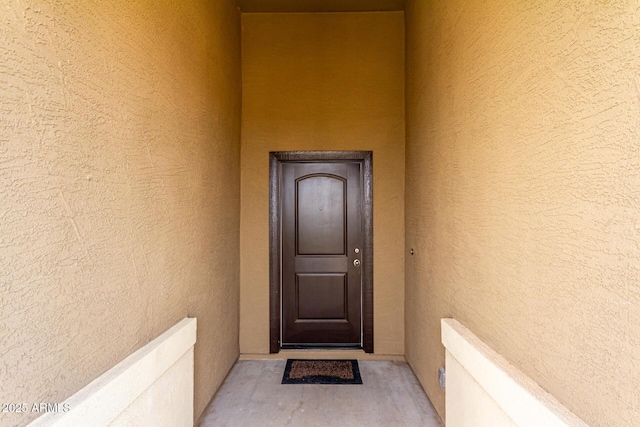 doorway to property with stucco siding