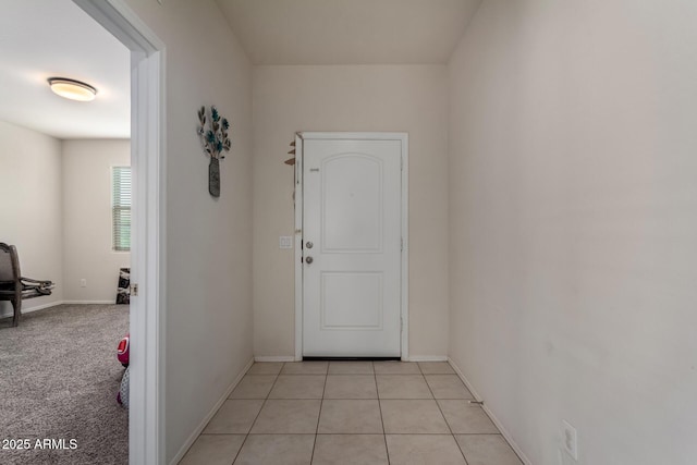 interior space featuring light tile patterned floors and baseboards