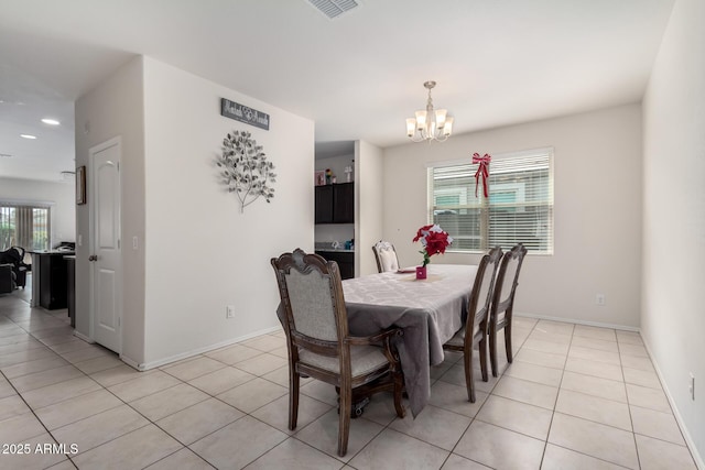dining area featuring baseboards, visible vents, an inviting chandelier, and light tile patterned floors
