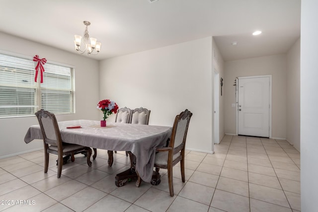 dining area with light tile patterned floors, baseboards, and a chandelier