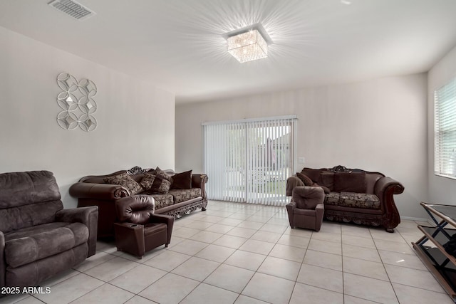 living room with light tile patterned flooring and visible vents