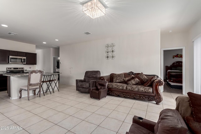 living room featuring visible vents, an inviting chandelier, recessed lighting, and light tile patterned floors