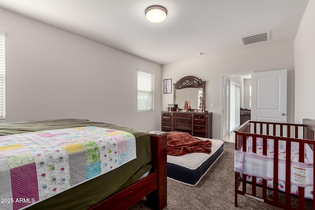 bedroom with visible vents and carpet flooring