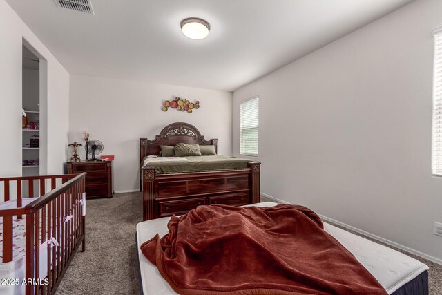 carpeted bedroom featuring baseboards and visible vents