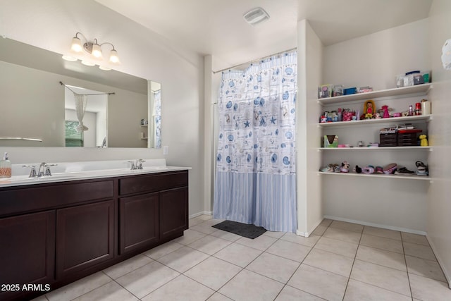 full bathroom featuring visible vents, a sink, tile patterned floors, and double vanity