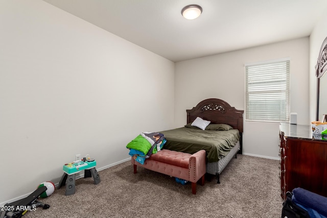 bedroom with baseboards and carpet floors