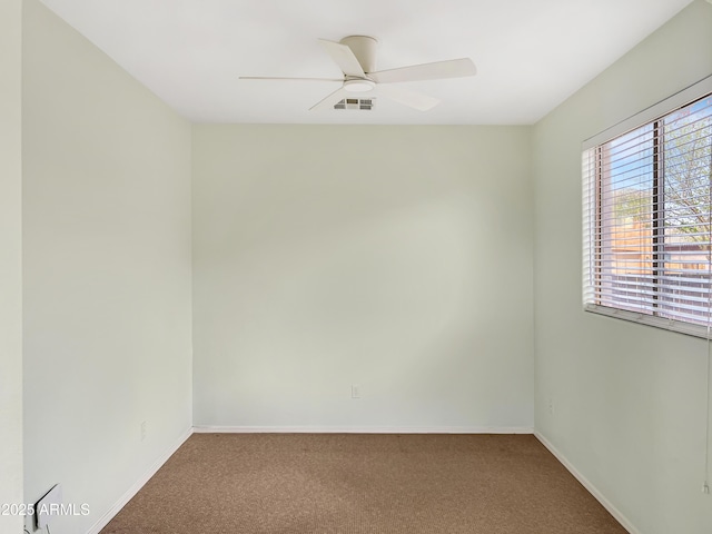 spare room with visible vents, baseboards, carpet, and ceiling fan