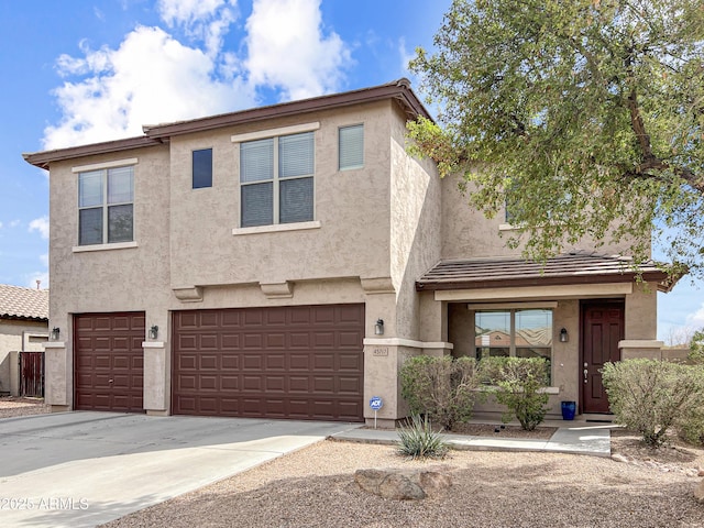 view of front of house with an attached garage, driveway, and stucco siding