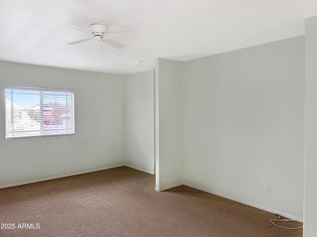 empty room with baseboards, ceiling fan, and carpet flooring