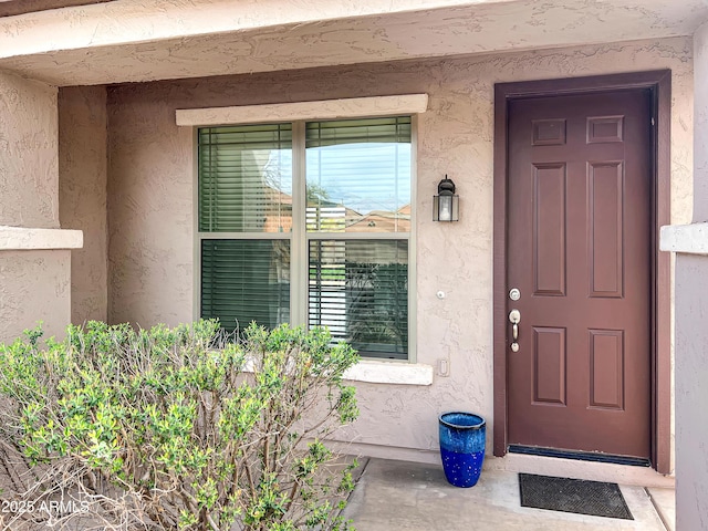 entrance to property with stucco siding