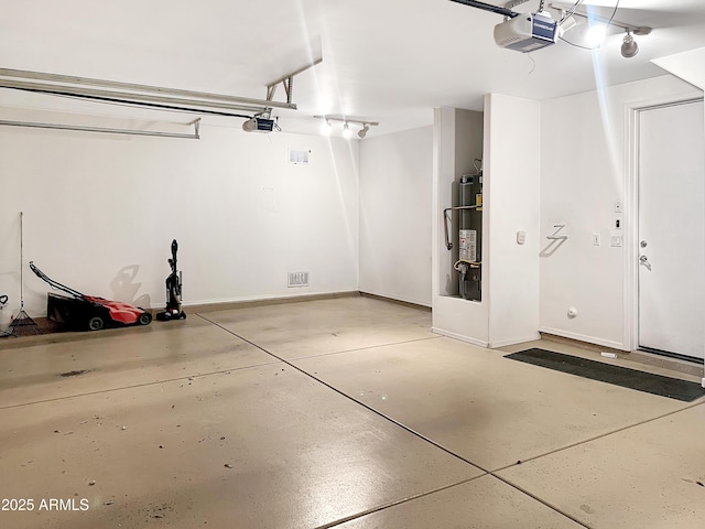 garage with gas water heater, a garage door opener, and baseboards