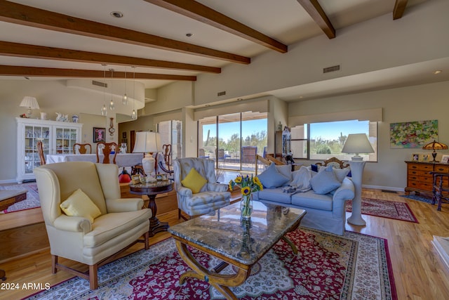 living room featuring light hardwood / wood-style flooring and vaulted ceiling with beams