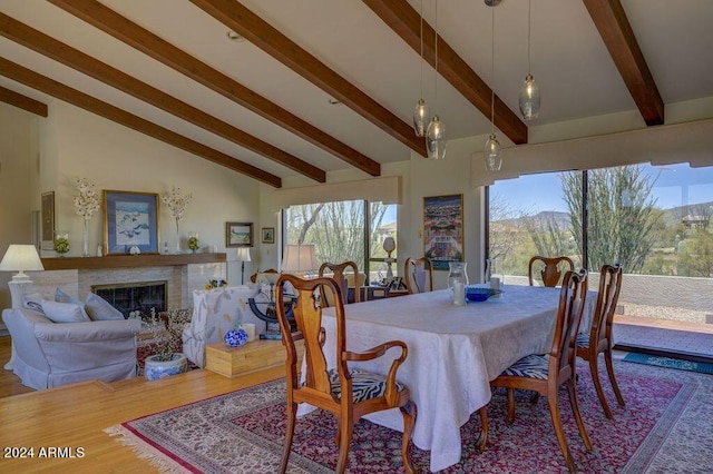 dining room with high vaulted ceiling, wood-type flooring, and beamed ceiling