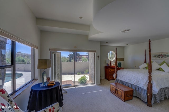 bedroom with light carpet, access to exterior, and multiple windows