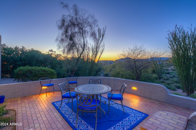 view of patio terrace at dusk