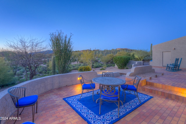 view of patio terrace at dusk