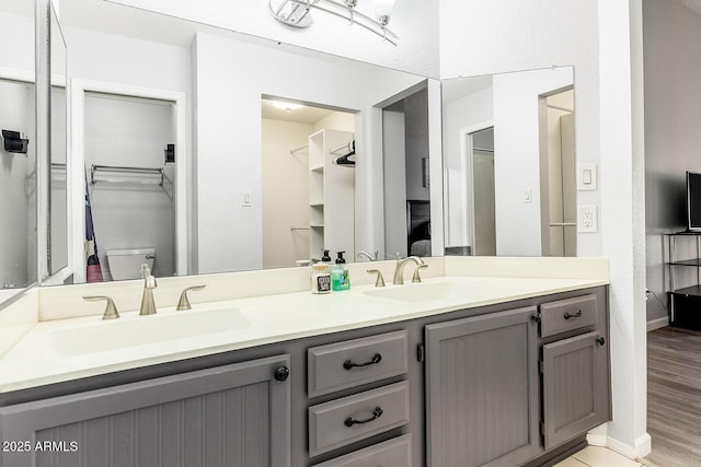 1601 E Cindy St, Chandler, AZ 85225 - full bathroom with double vanity, wood finished floors, a spacious closet, and a sink