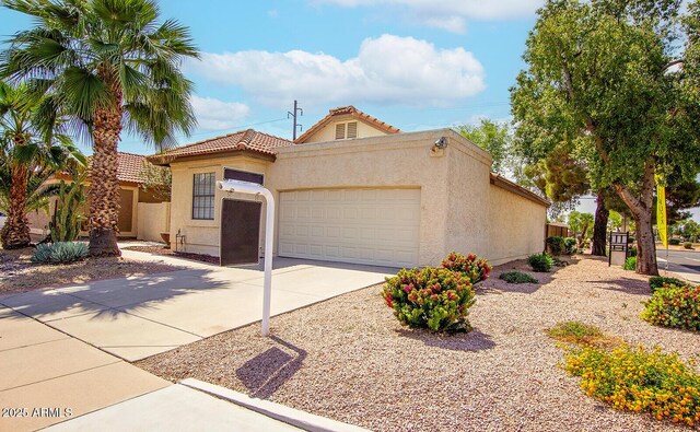 1601 E Cindy St, Chandler, AZ 85225 - view of front of home with driveway, stucco siding, a tiled roof, and a garage