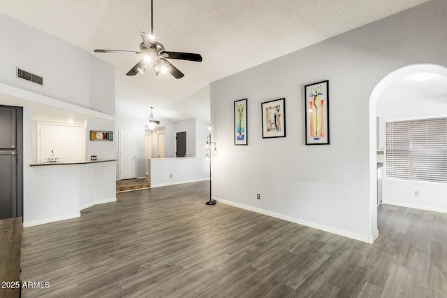 1601 E Cindy St, Chandler, AZ 85225 - unfurnished living room featuring vaulted ceiling, ceiling fan, visible vents, and dark wood finished floors
