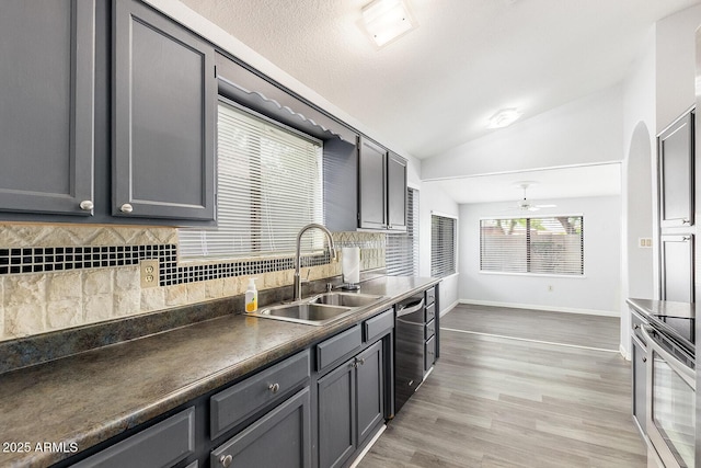 1601 E Cindy St, Chandler, AZ 85225 - kitchen with baseboards, a sink, vaulted ceiling, backsplash, and appliances with stainless steel finishes