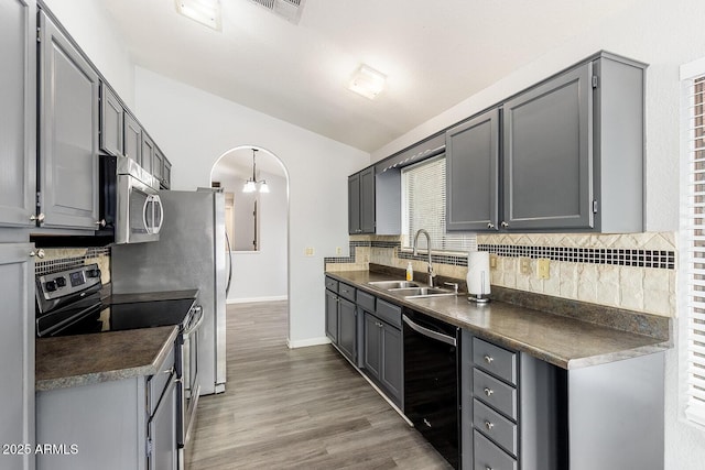1601 E Cindy St, Chandler, AZ 85225 - kitchen featuring wood finished floors, a sink, dark countertops, stainless steel appliances, and backsplash