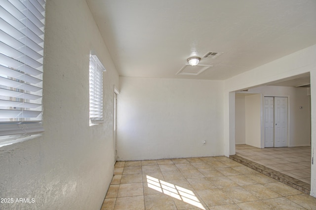 spare room with light tile patterned floors and visible vents