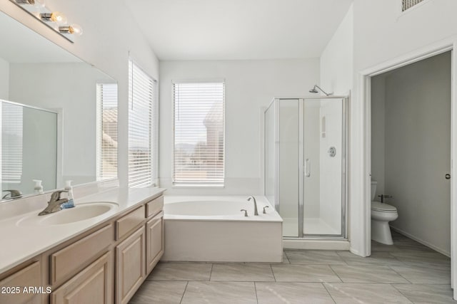 bathroom with toilet, a garden tub, a shower stall, and vanity