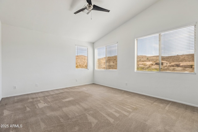 unfurnished room with a ceiling fan, light carpet, vaulted ceiling, and baseboards