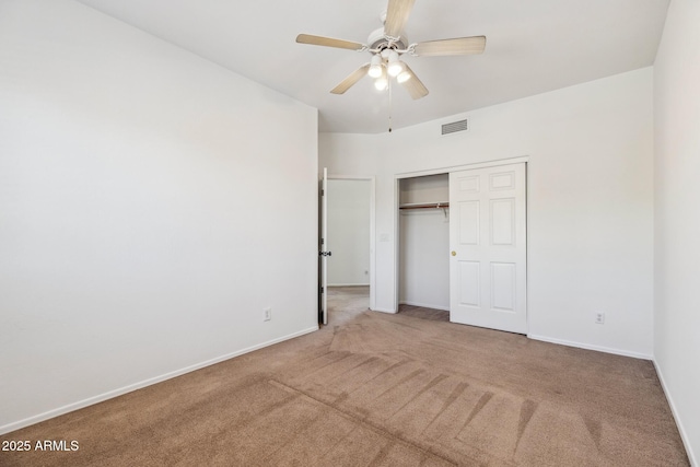 unfurnished bedroom with carpet, a closet, visible vents, a ceiling fan, and baseboards