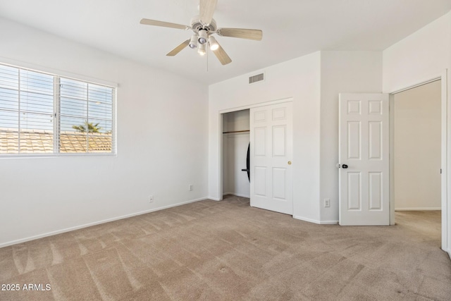 unfurnished bedroom with light carpet, baseboards, visible vents, and a closet