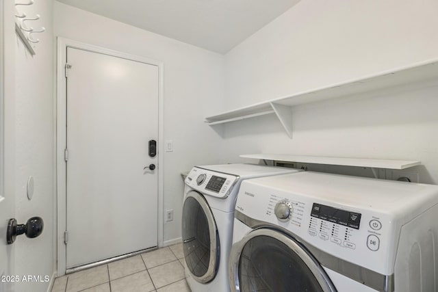 laundry room featuring washer and dryer, laundry area, and light tile patterned floors