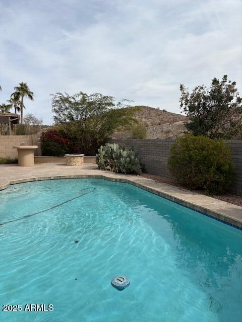 view of swimming pool with a fenced backyard and a fenced in pool