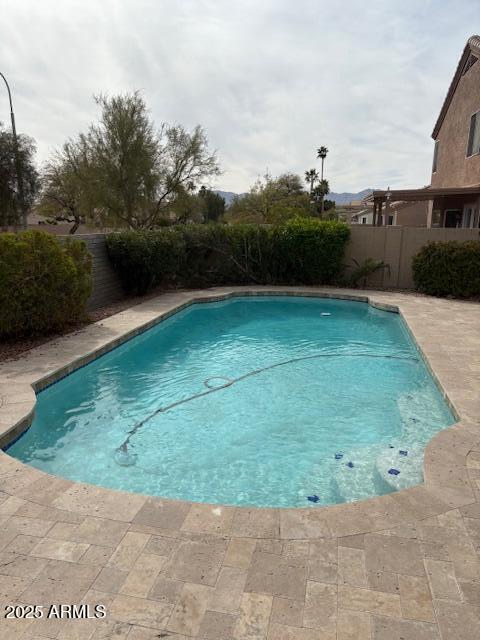 view of swimming pool featuring a fenced in pool, a fenced backyard, and a patio