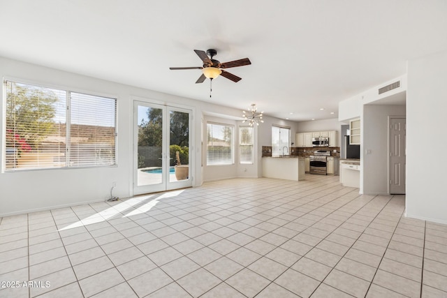 unfurnished living room featuring light tile patterned floors, a sink, visible vents, and recessed lighting