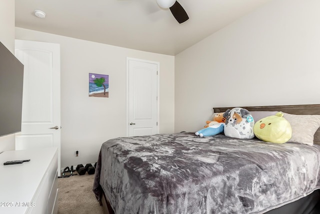 carpeted bedroom featuring ceiling fan and vaulted ceiling