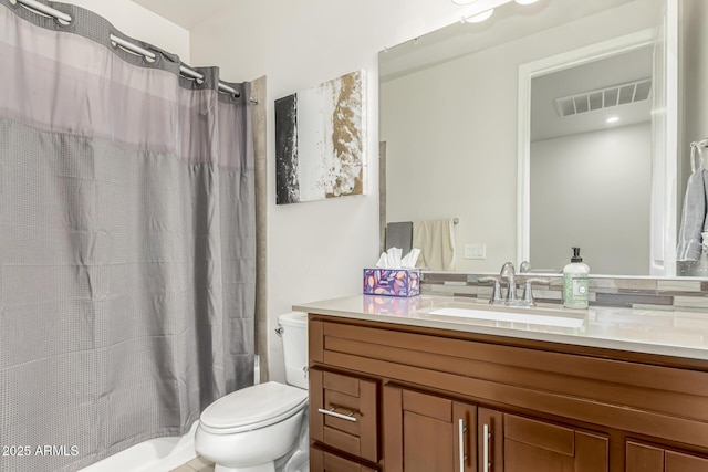 full bathroom with vanity, shower / bath combo, and toilet