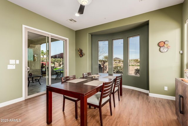 dining area featuring light wood-style floors, baseboards, visible vents, and ceiling fan