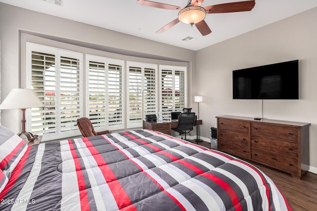 bedroom with ceiling fan, dark wood-style flooring, visible vents, and baseboards