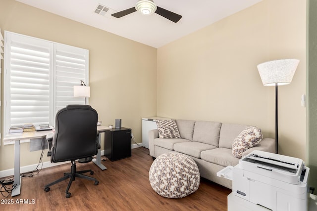 office space with a ceiling fan, visible vents, baseboards, and wood finished floors