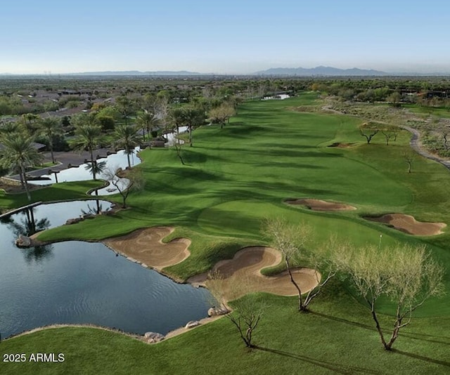 view of property's community with view of golf course and a water view