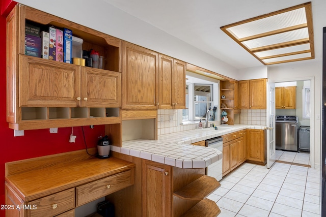 kitchen featuring light tile patterned floors, dishwasher, a sink, and open shelves