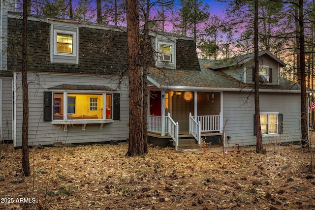 view of front of home with covered porch and a shingled roof