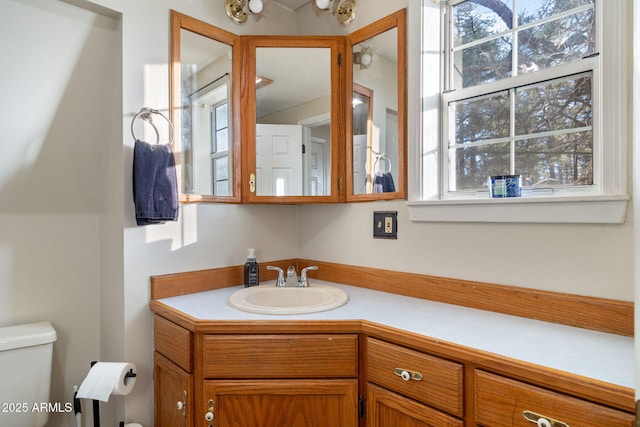 bathroom featuring vanity and toilet