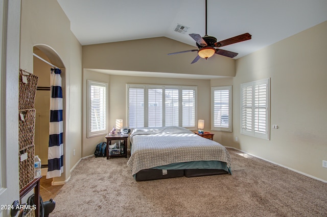 bedroom featuring multiple windows, ceiling fan, light carpet, and lofted ceiling