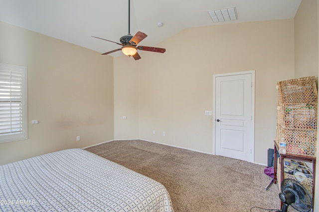 carpeted bedroom with ceiling fan and vaulted ceiling