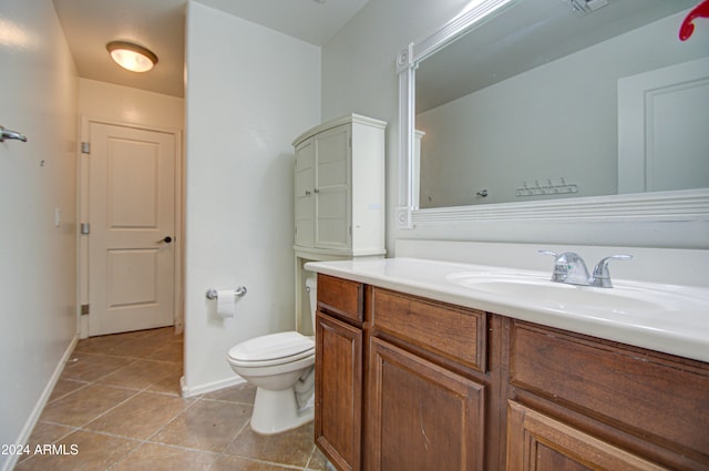 bathroom with tile patterned floors, vanity, and toilet