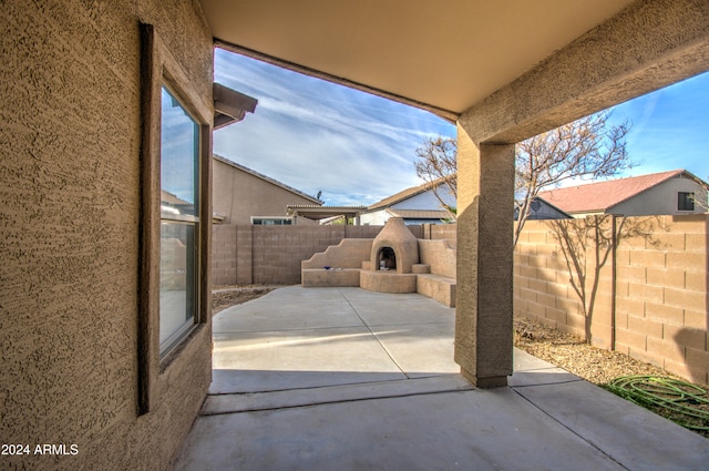 view of patio with exterior fireplace