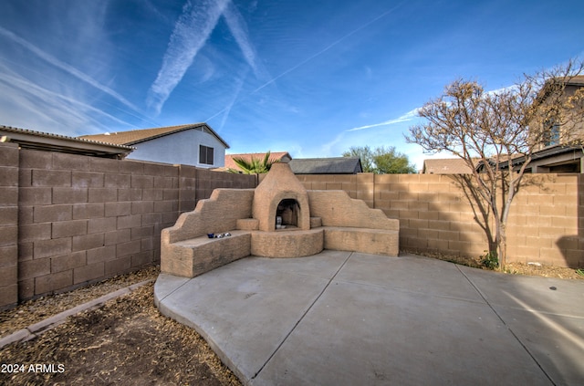 view of patio with exterior fireplace